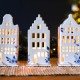 Ceramic tealight holder of a Dutch canal house with spout facade with elegant Delft blue decoration. The tea lights are easy to replace because the house is on a separate platform.