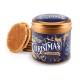Stroopwafels in een speciaal voor kerstmis ontworpen stroopwafelblik. Een stroopwafelblik met kerstmis decoraties op een blauwe achtergrond